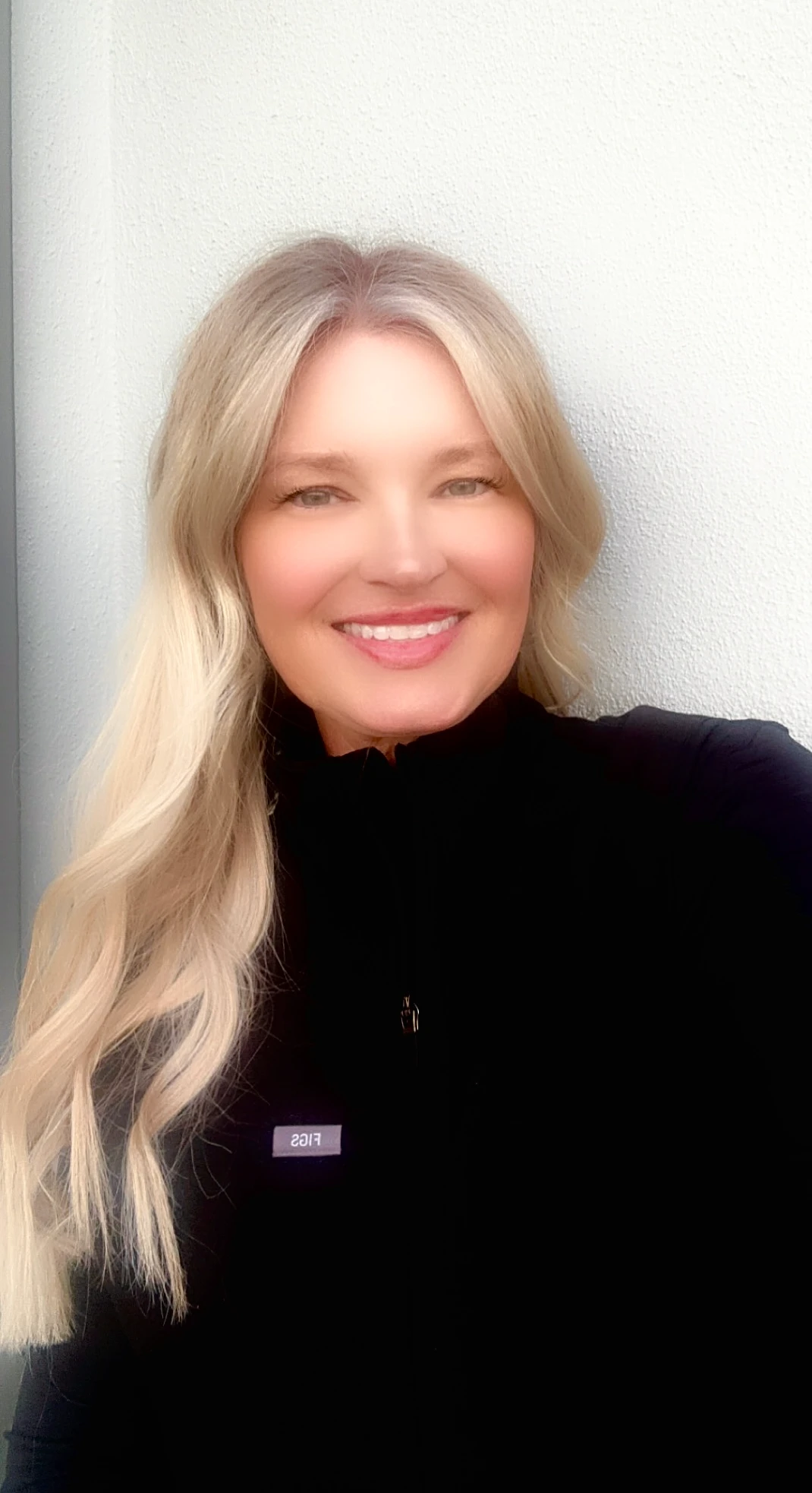 Agnes Lech, RN, at Lounge of Beauty Medical Spa, smiling confidently in a professional setting.